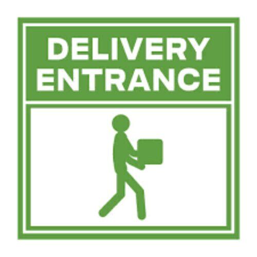 Green "Delivery Entrance" sign on a metal gate.
