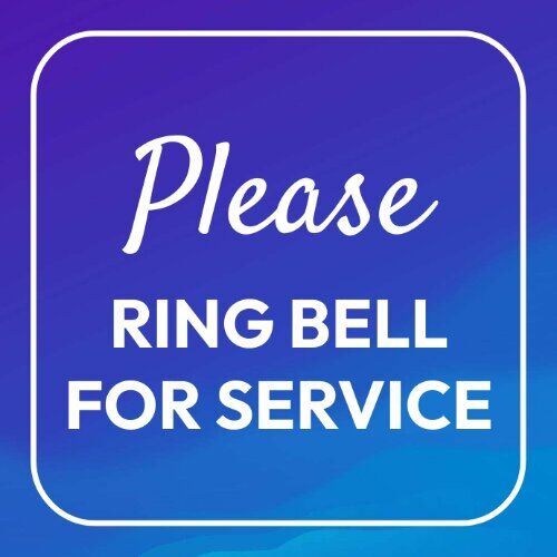 "Please Ring Bell for Service" sign on a clean counter in a Lagos shop.